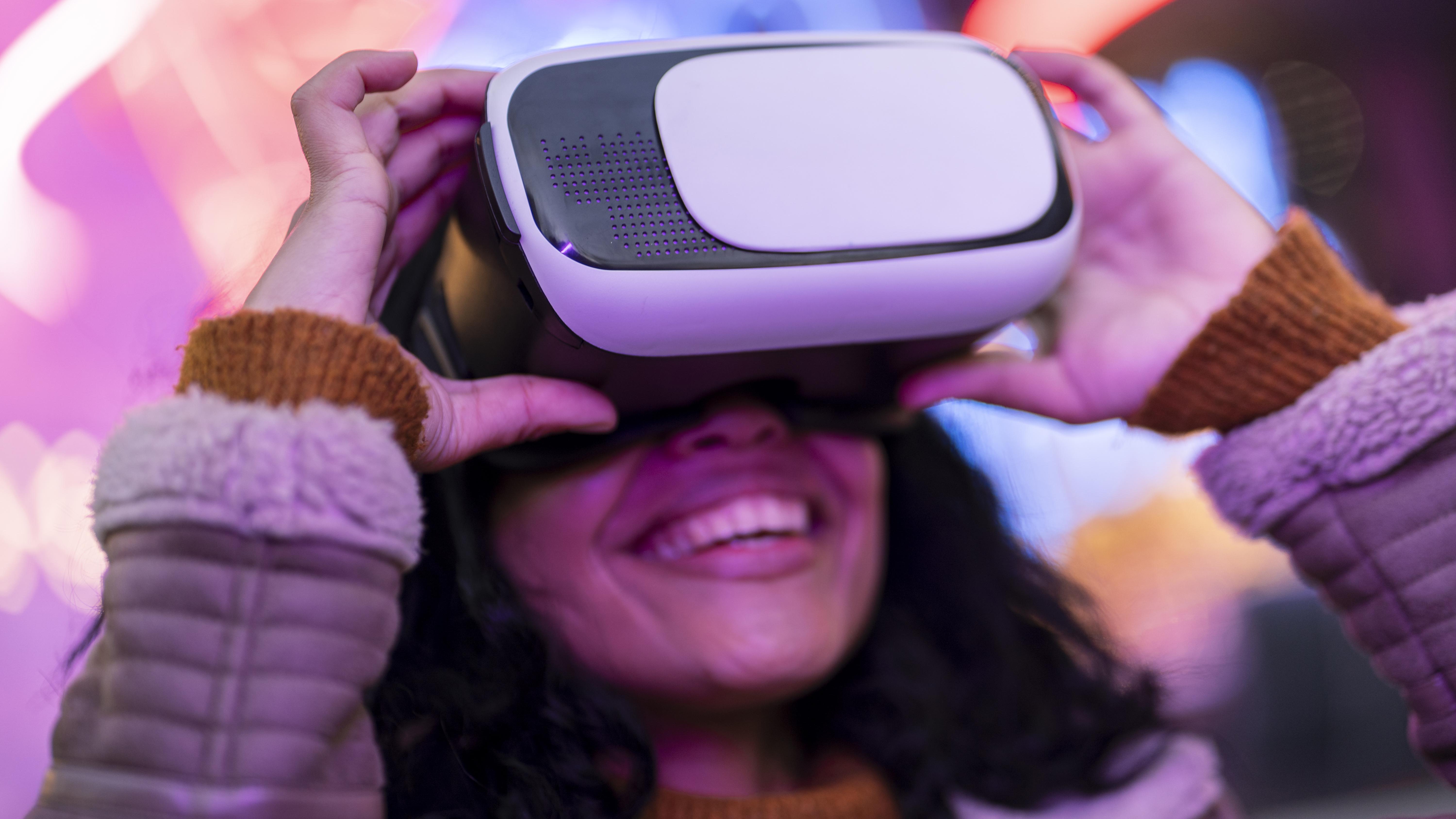 smiley woman using virtual reality goggles